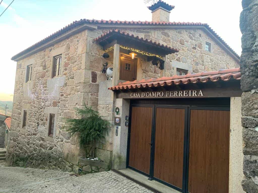 Stone building entrance for Casa D'Campo Ferreira on a cobblestone street