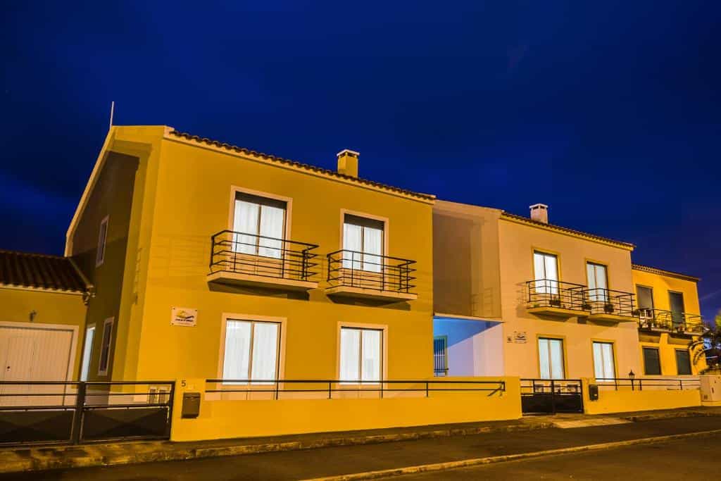 Yellow apartment buildings illuminated at night near Areal de Santa Barbara