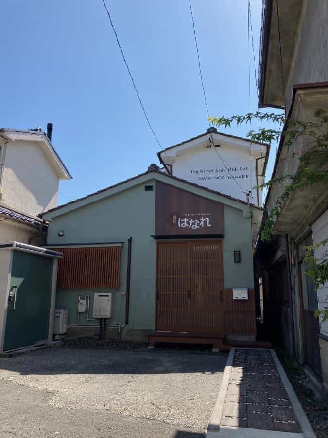 Hanare Matsumoto building exterior with Japanese signage under a clear blue sky.