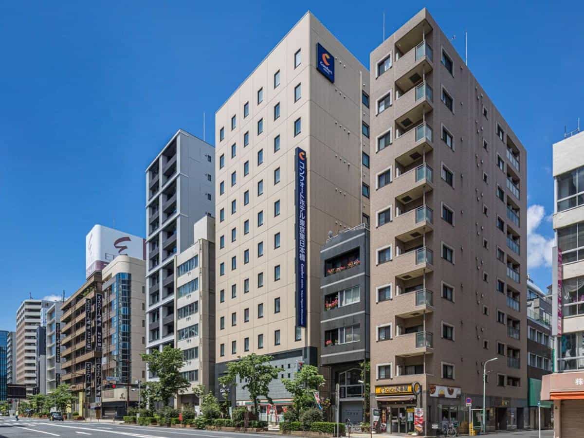Comfort Hotel Higashi-Nihombashi facade on a city street under a clear blue sky.