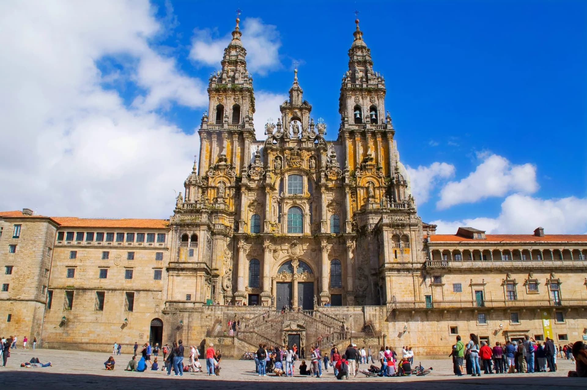 Cathedral of Santiago de Compostela facade with ornate towers and people in the plaza.
