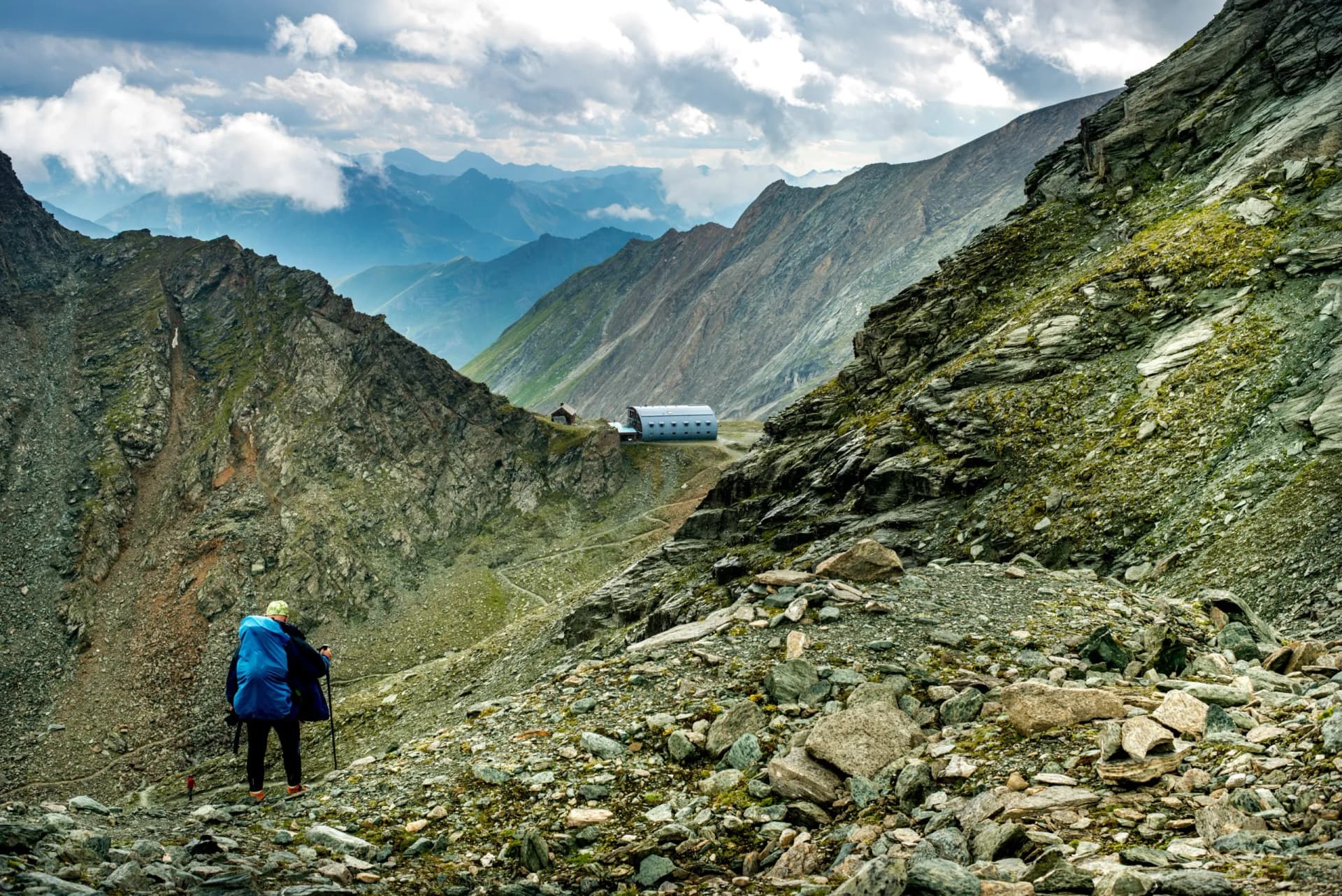 Men is walking on a road to Studlhutte shelter below Grossglockn