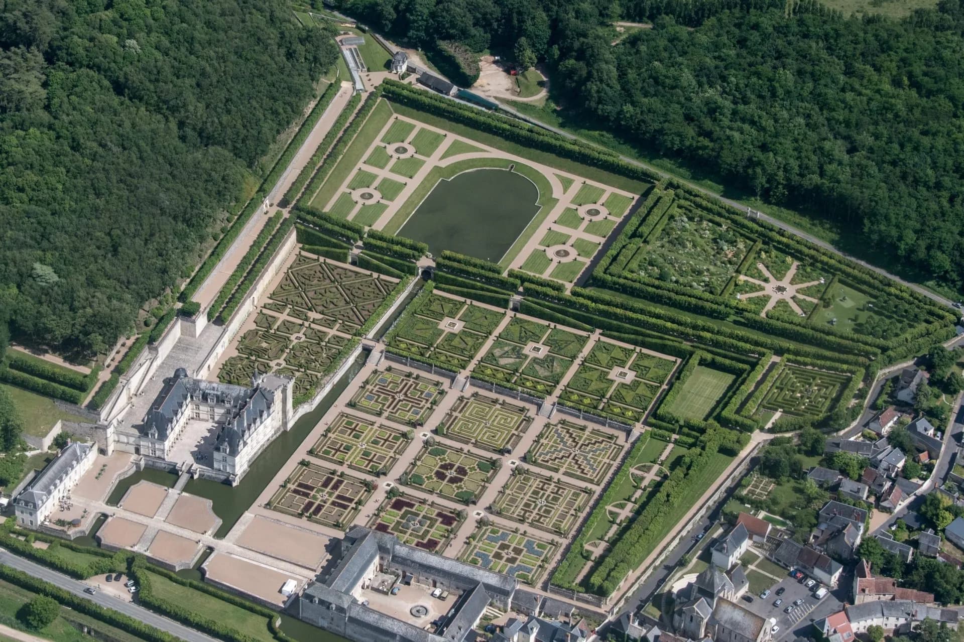 Aerial view of Château de Villandry gardens with intricate knot gardens and reflecting pool.
