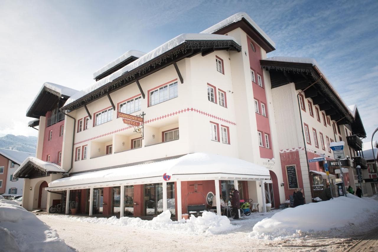 Biohotel Garmischer Hof hotel building covered in snow in an alpine village setting