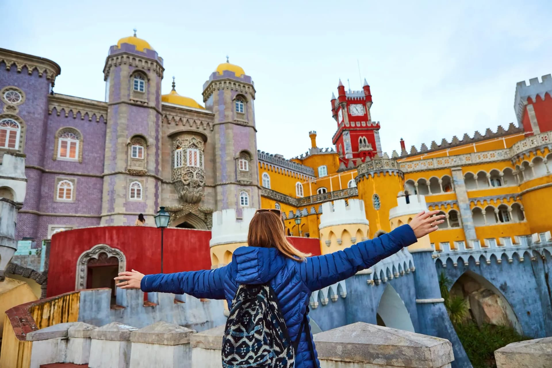 Young woman tourist walks in Pena Palace, Sintra, Portugal . Travel and tourism in Europe