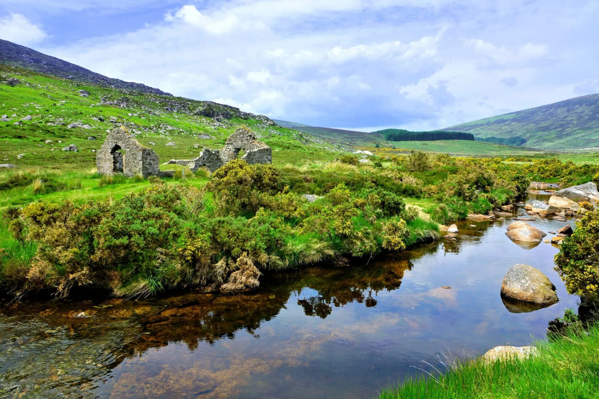 Ruined mining building along a picturesque creek in the hills of Wicklow Mountains National Park, Ireland