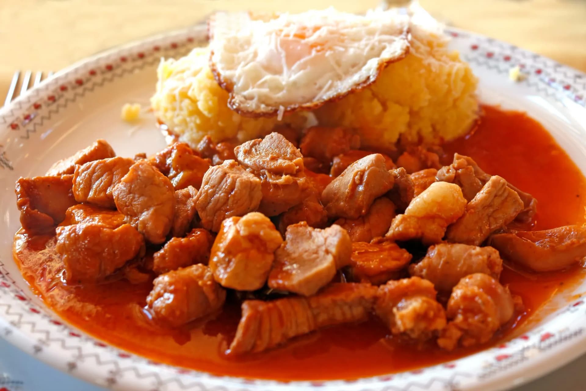 Tochitura Romanian dish made  beef and pork served polenta eggs.