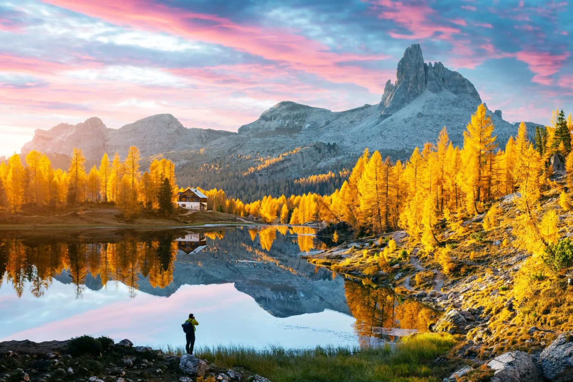 Picturesque view on Federa Lake in sunrise time. Autumn mountains landscape with Lago di Federa and bright orange larches in the Dolomite Apls, Cortina D'Ampezzo, South Tyrol, Dolomites, Italy