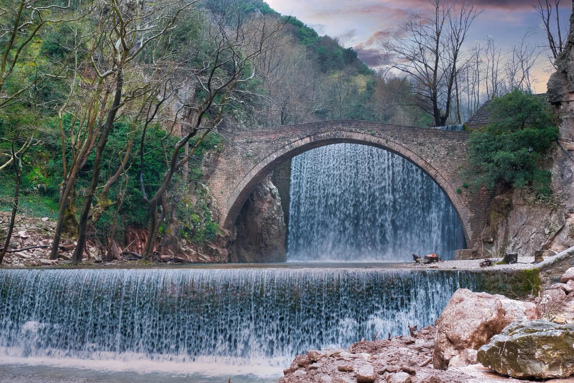 Ancient stone bridge meets twin waterfalls in Trikala