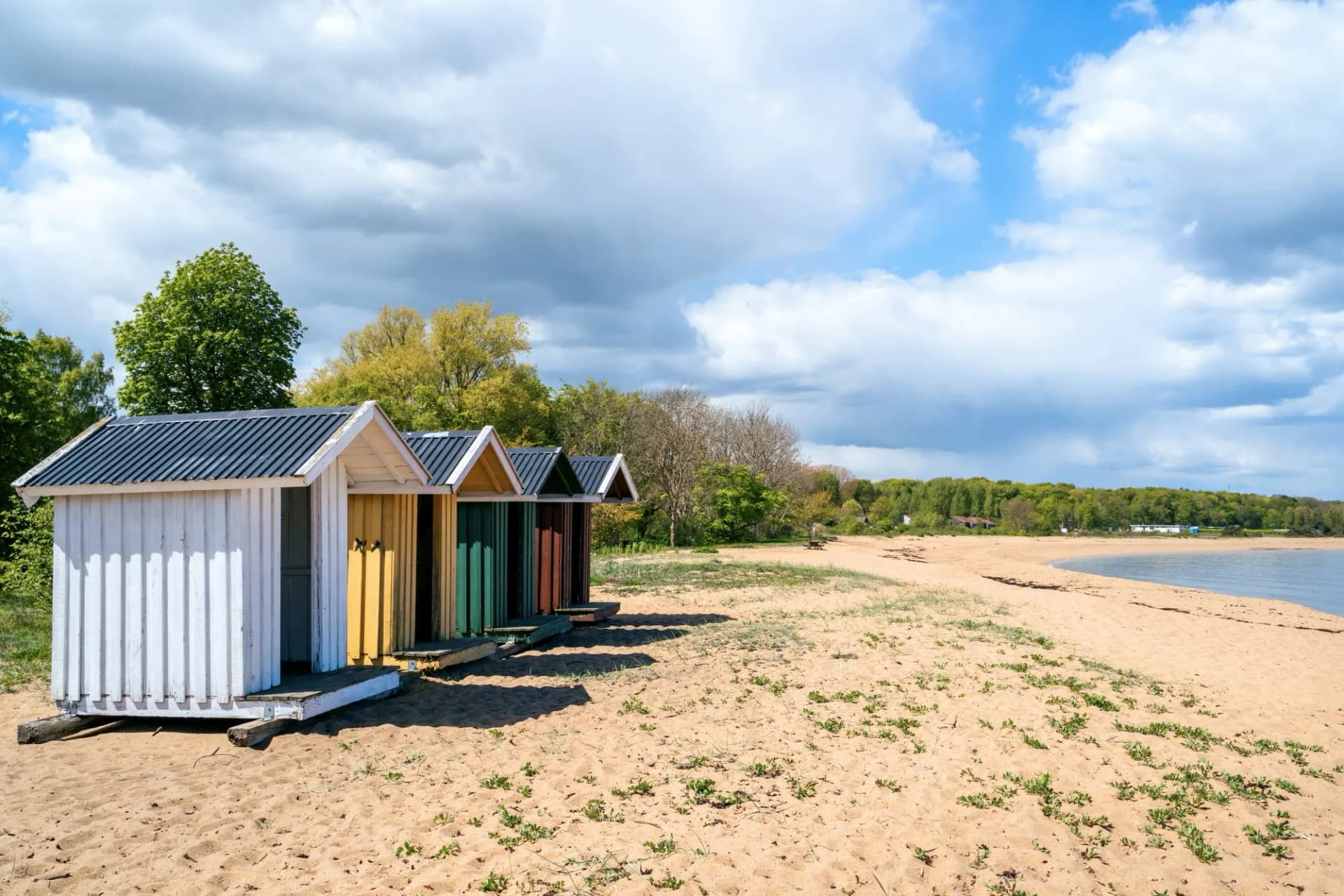 Colourful beach huts in a row on the beach in Simrishamn, Skane, Sweden