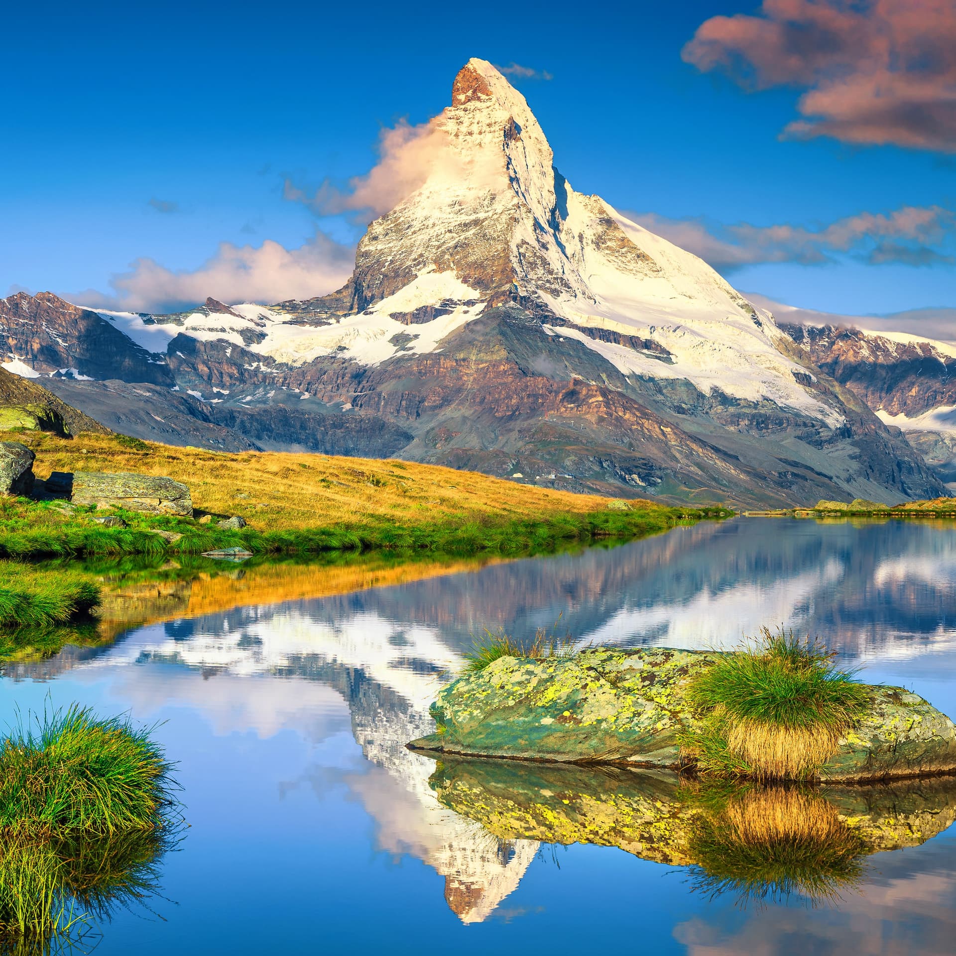 Matterhorn mountain reflecting in a calm alpine lake in Zermatt, Switzerland.
