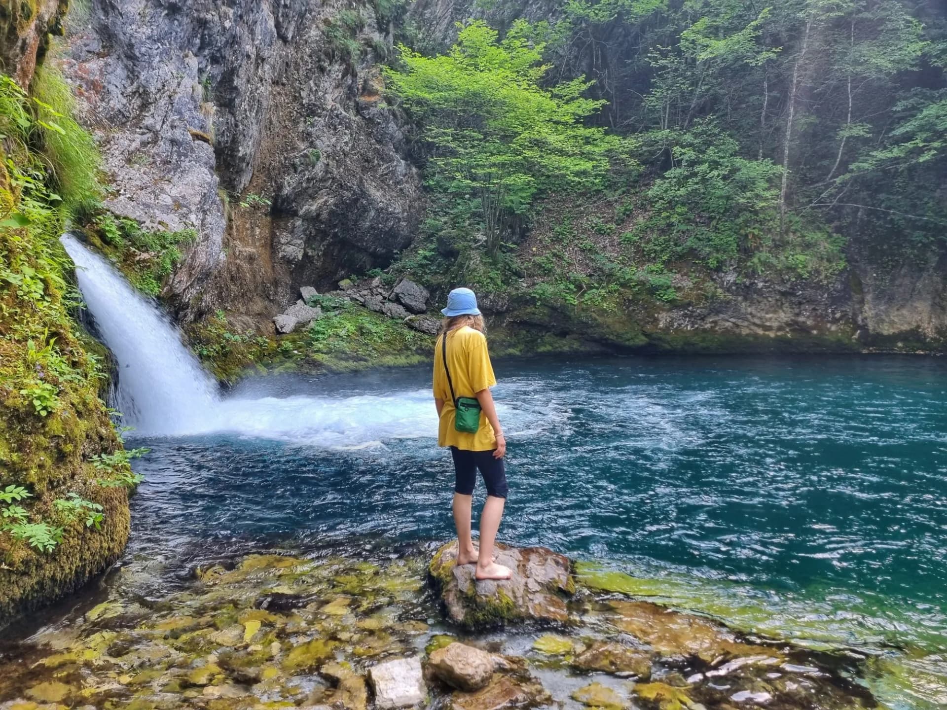 person on the Blue Eye waterfall in Albania