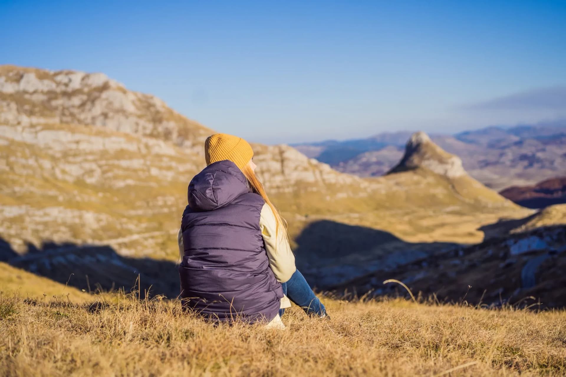 Montenegro. Woman tourist on the background of Durmitor National Park. Saddle Pass. Alpine meadows. Mountain landscape. Travel around Montenegro concept