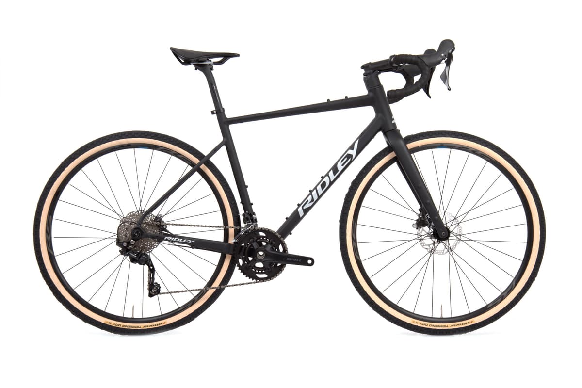 Matte black Ridley Kanzo Adventure gravel bike with tan-wall tires and Shimano GRX drivetrain.