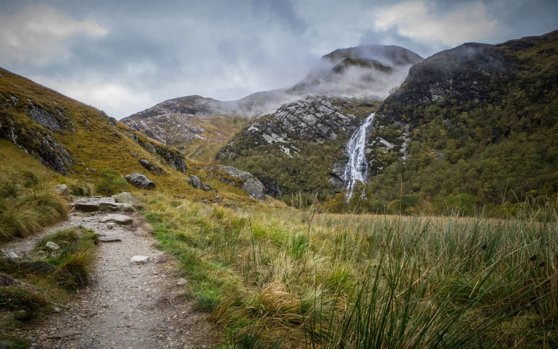 A view from a hill above the River Nevis towards the Steall Waterfall in Glen Nevis, Scotland on a summers day