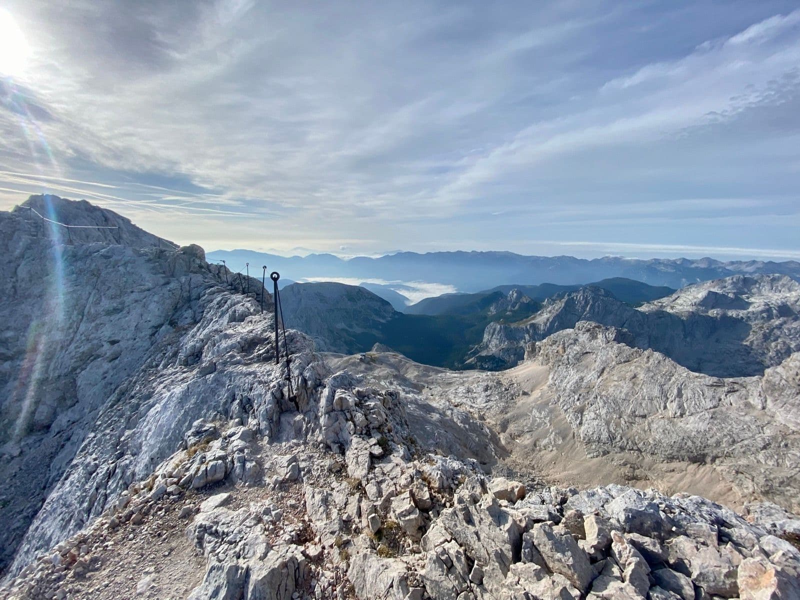 Rocky mountain ridge with a metal safety cable on Mount Triglav, Slovenia.