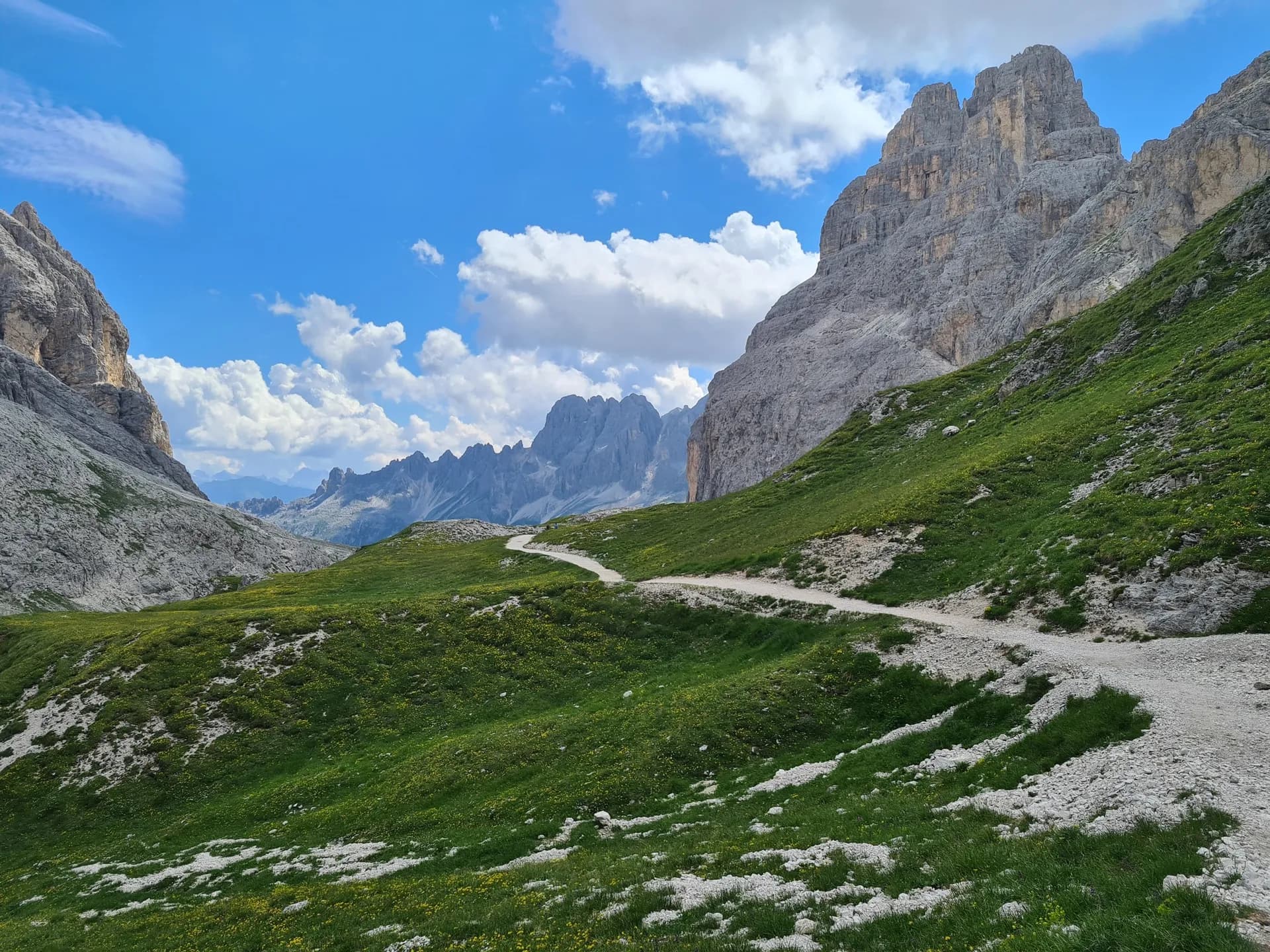 Hiking trail winding through the Seiser Alm and Rosengarten mountains in the Dolomites.