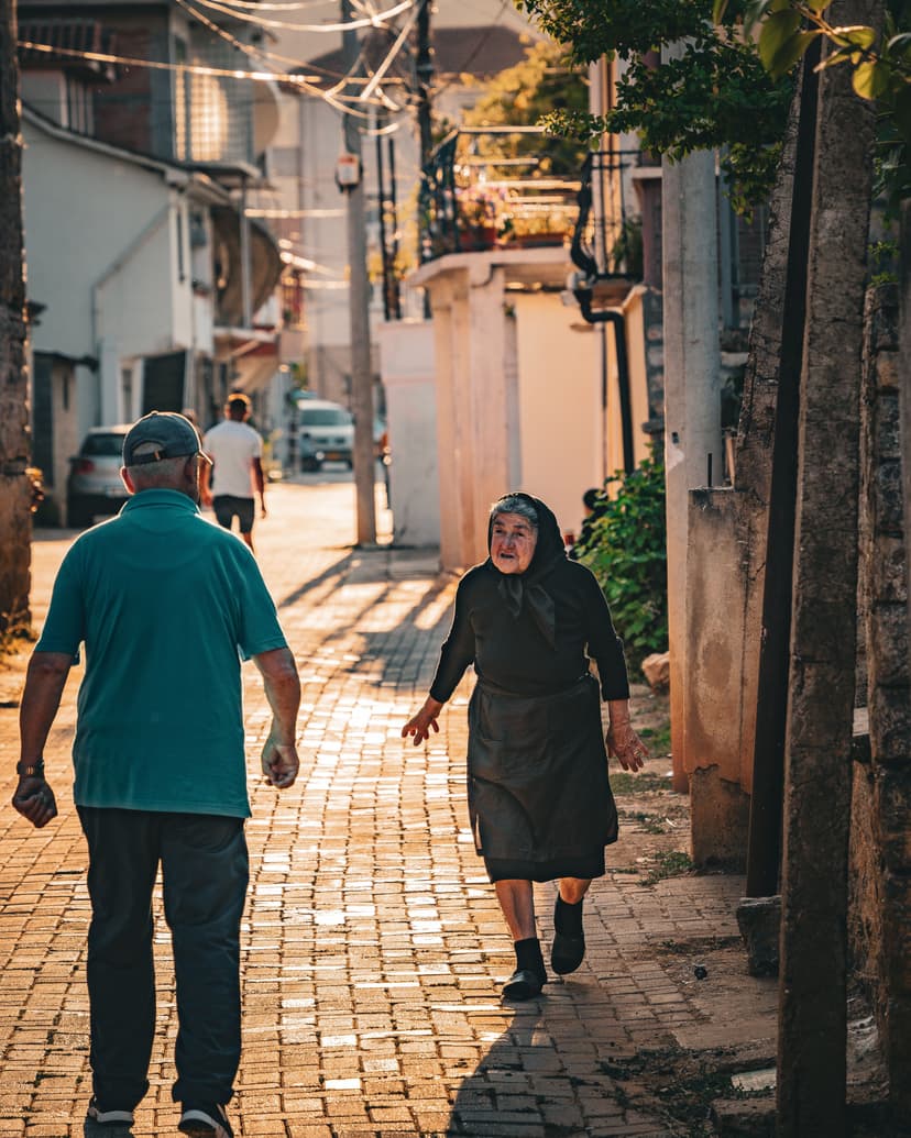 People walking on cobblestone street in town