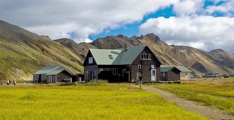 Landmannalaugar camping area with wooden huts set against mountains