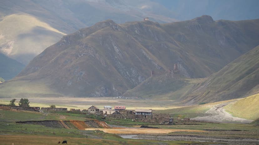 Stone towers and village in Truso Valley, Georgia, with mountains in the background