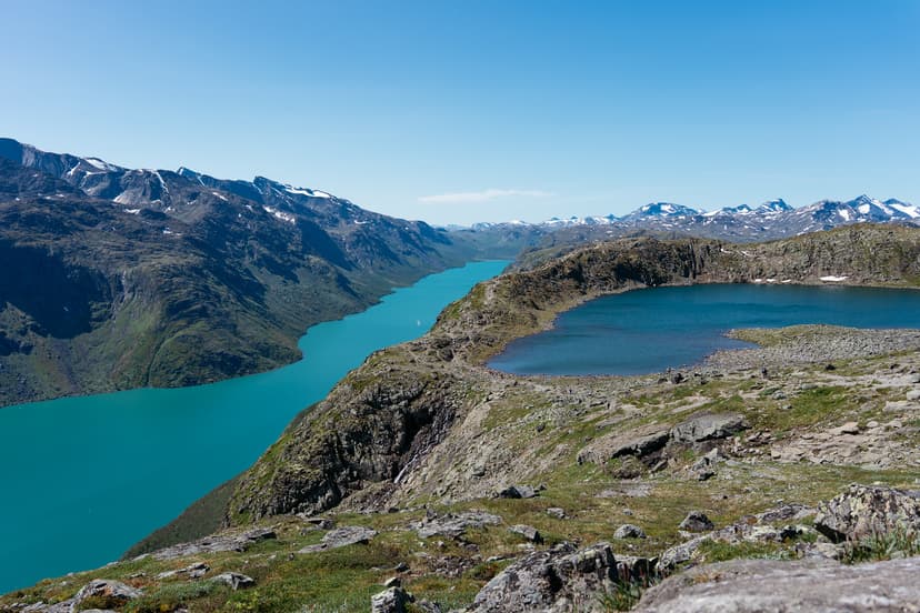 Besseggen ridge separating two lakes with turquoise water and surrounding mountain peaks
