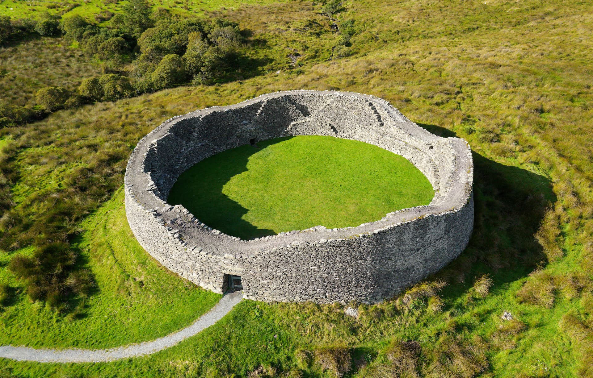 Stone ring fort ruins with bright green grass interior near Sneem, Ireland.