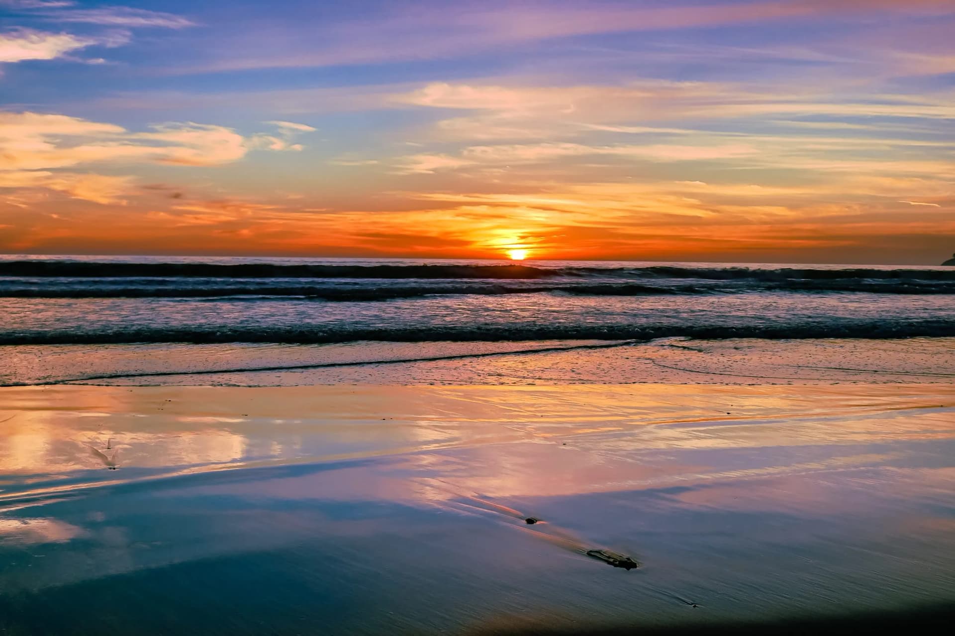 Sunset at Stinson Beach in California shows the beautiful colors of the sky reflecting off the sand