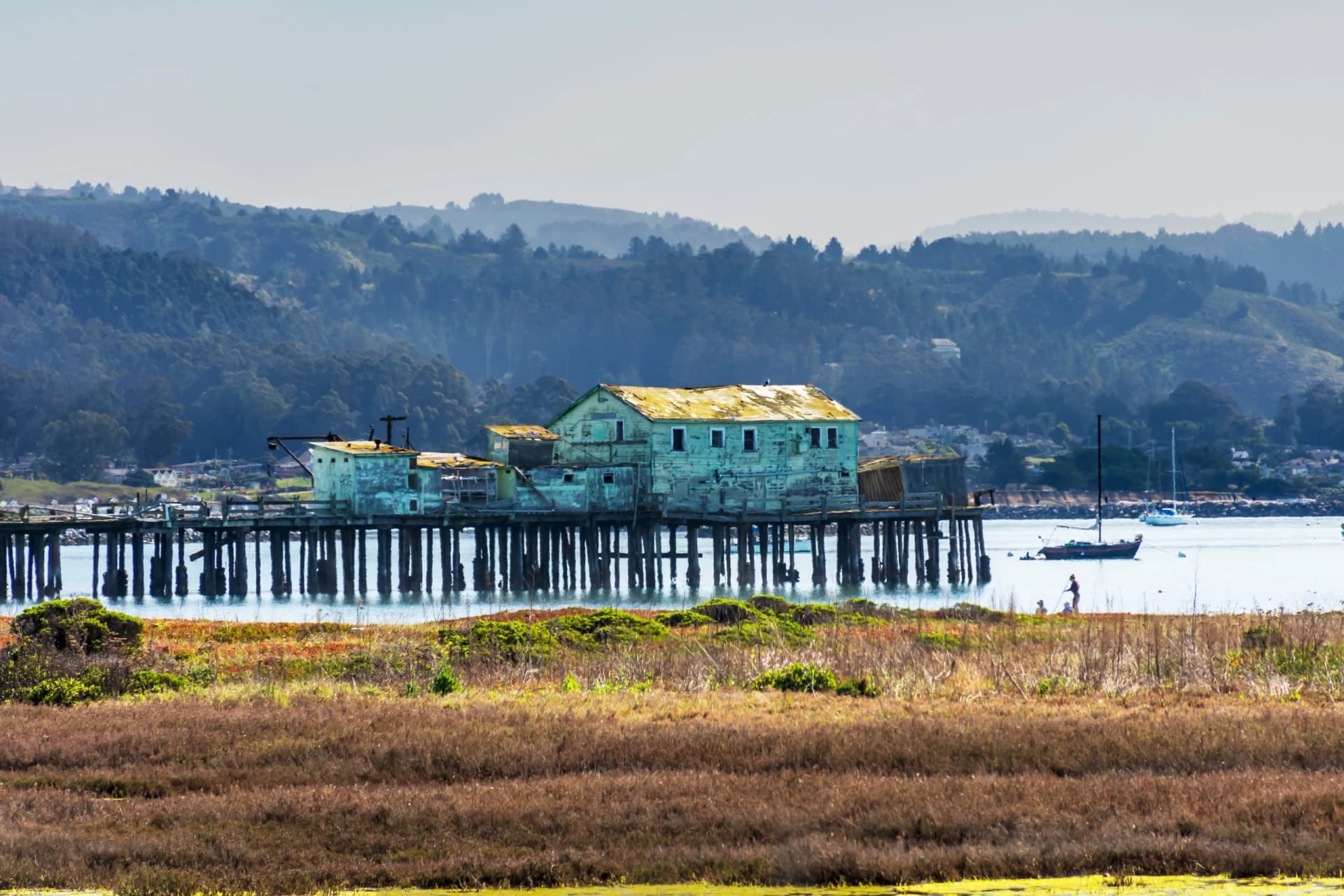 dilapidated building and pier in half moon bay, california