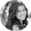 Black and white portrait of a smiling person with long hair