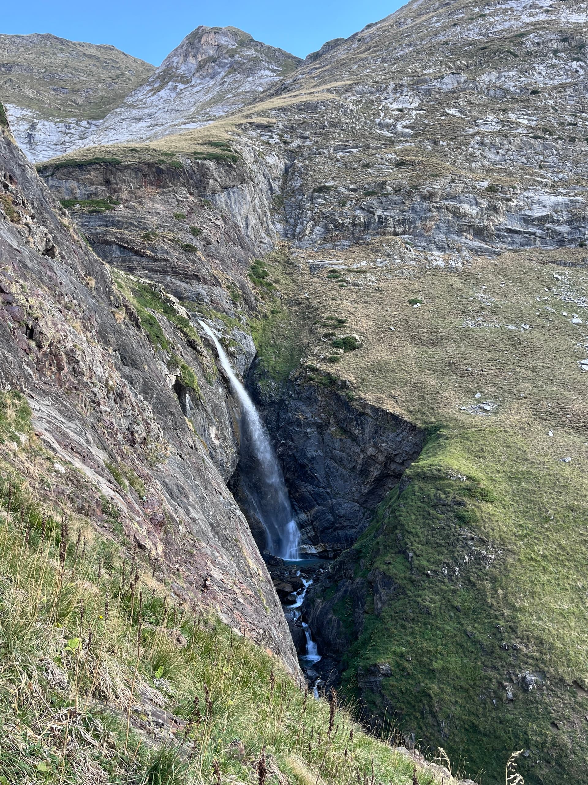 Waterfall flowing through a steep rocky mountain gorge