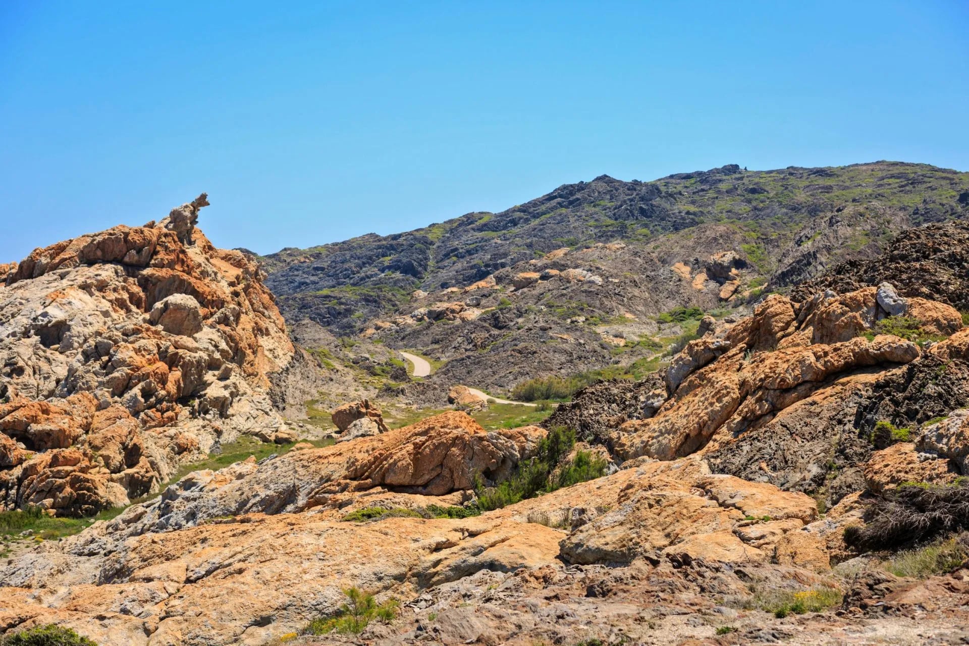 Contorted orange and grey rock formations on the Cap de Creus headland
