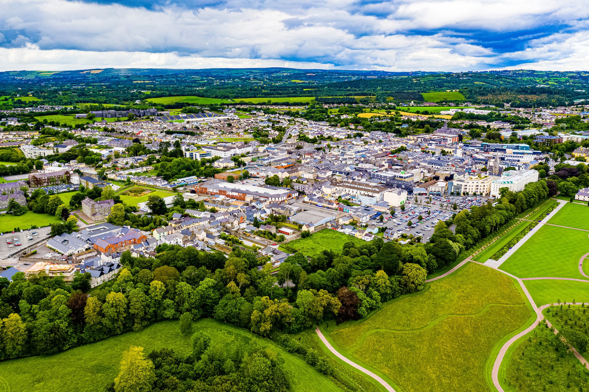 Killarney town seen from the air with woodland and mountains beyond