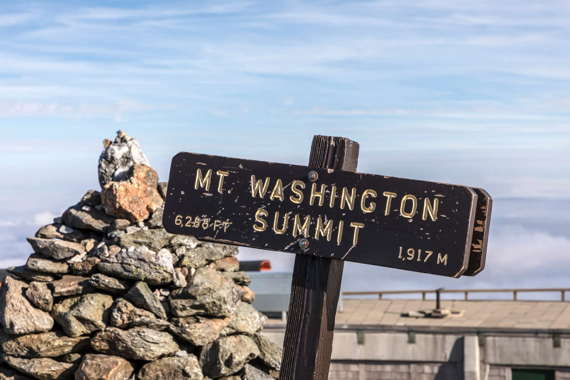 The summit sign on Mount Washington giving the height in feet and metres