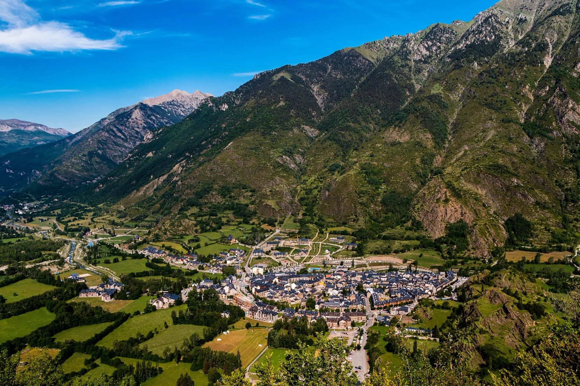 Benasque spread along its valley floor below wooded slopes and high peaks