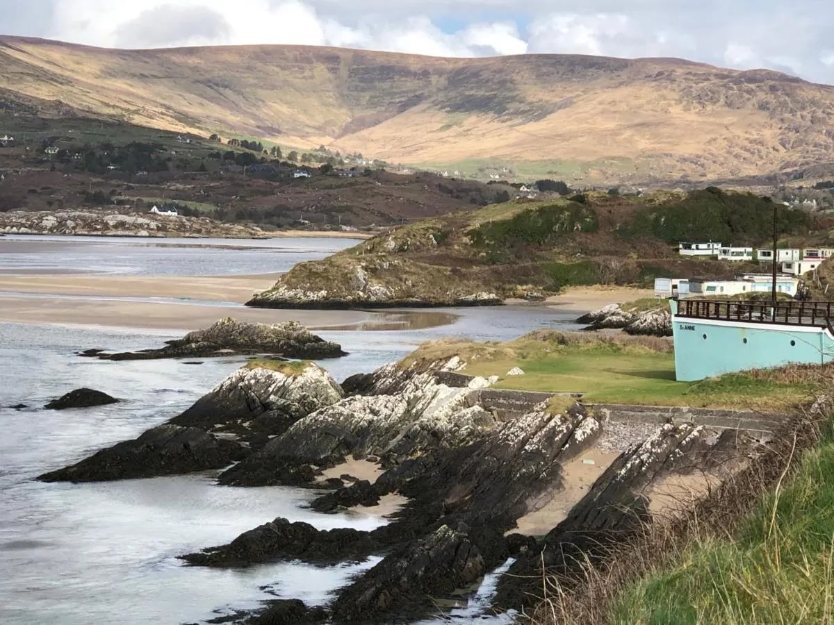 The Kerry coastline with beach and mountains beyond on the Iveragh Peninsula