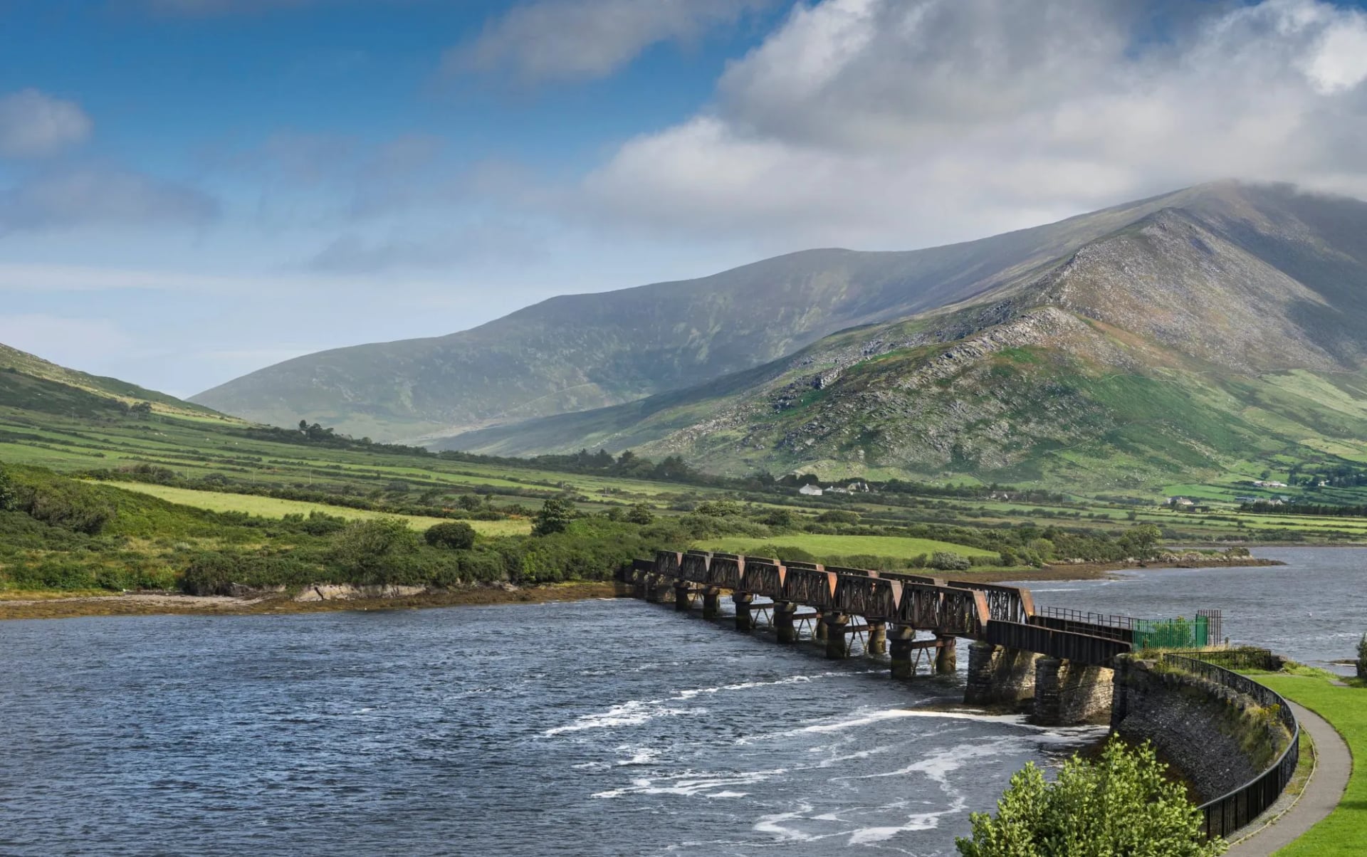 A low bridge crossing the water at Cahersiveen with mountains behind