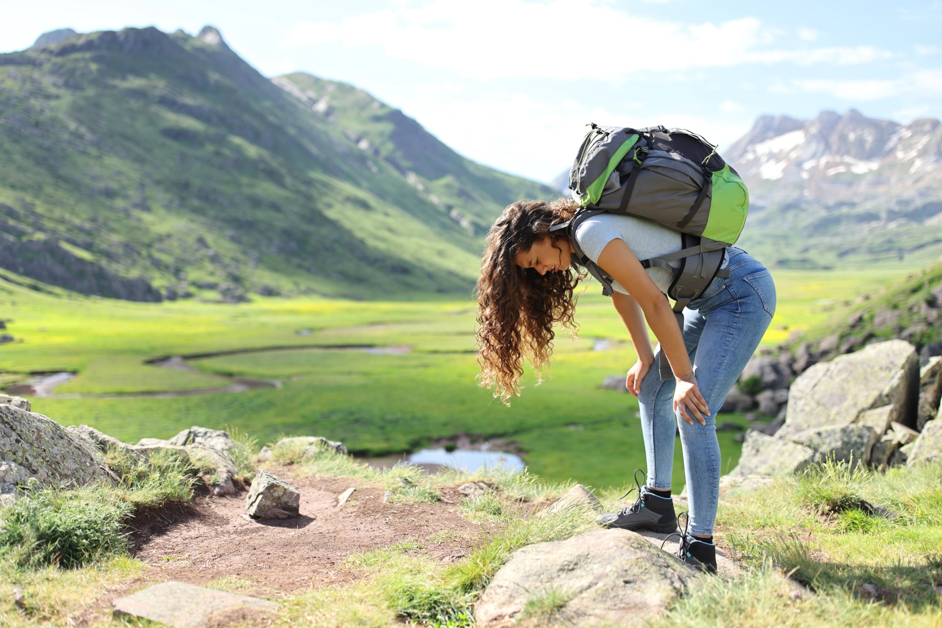 Exhausted hiker resting after climbing a mountain