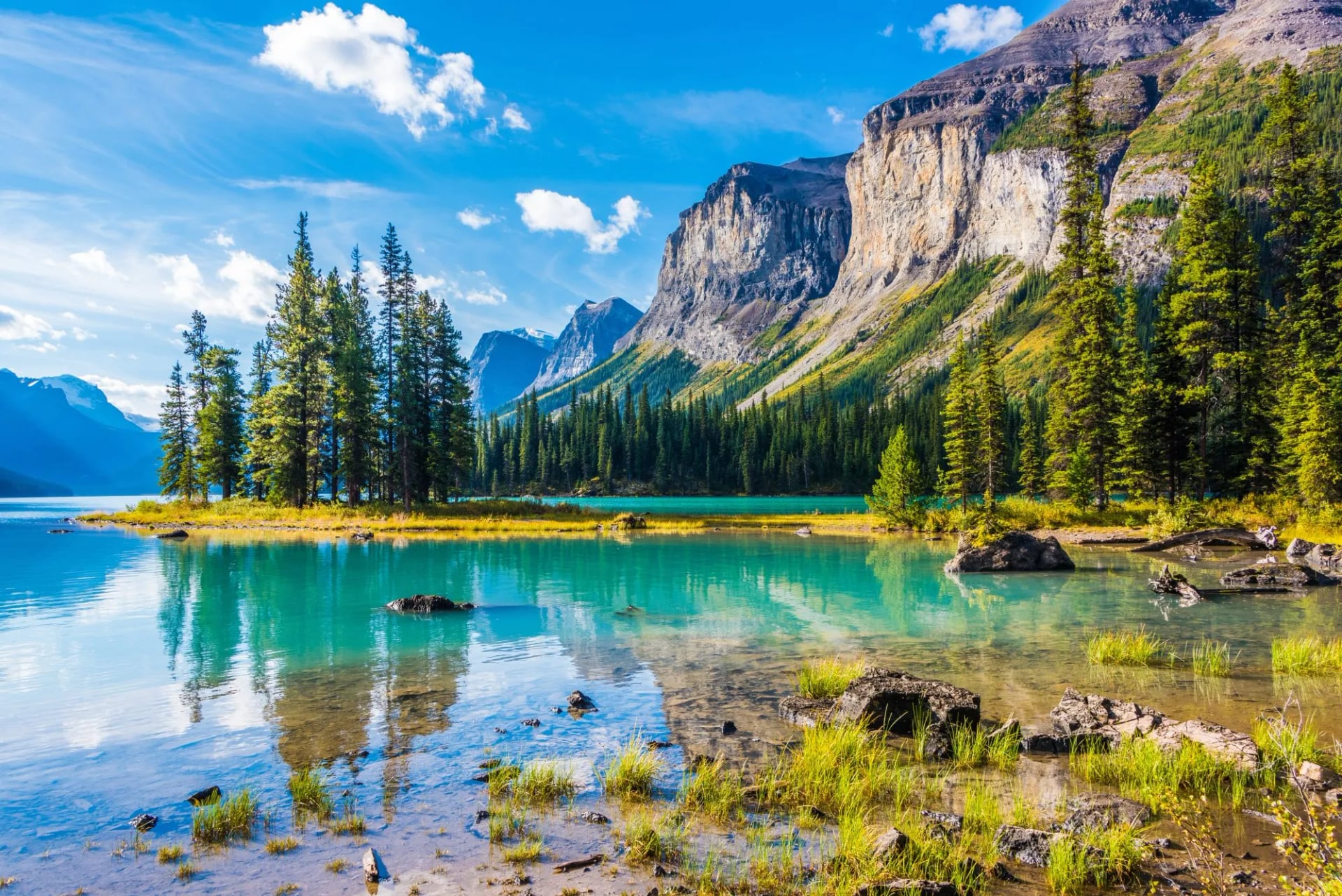 Maligne Lake with Spirit Island and turquoise water below snow-streaked peaks