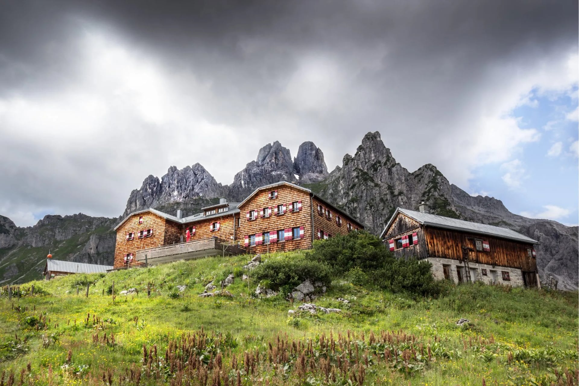 An alpine hut below jagged limestone peaks