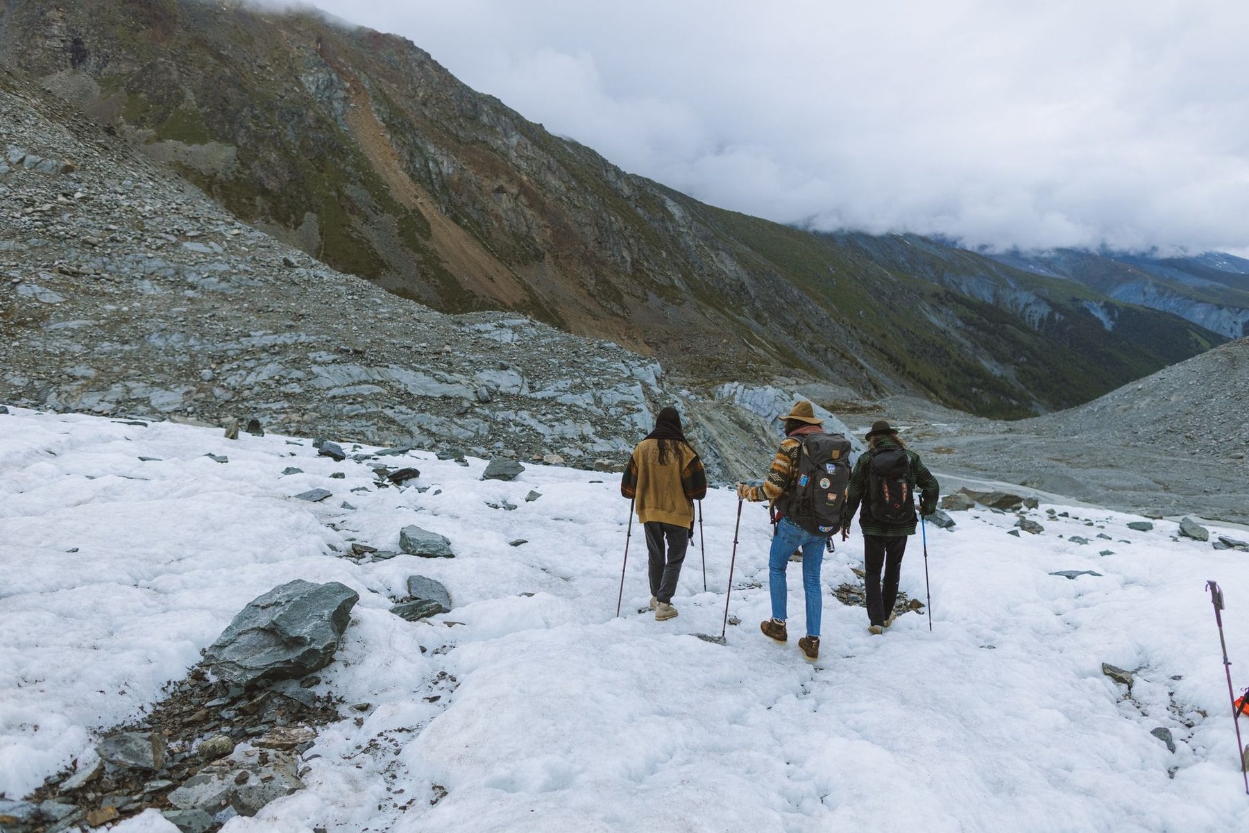 Walkers crossing an old snowfield high on a pass