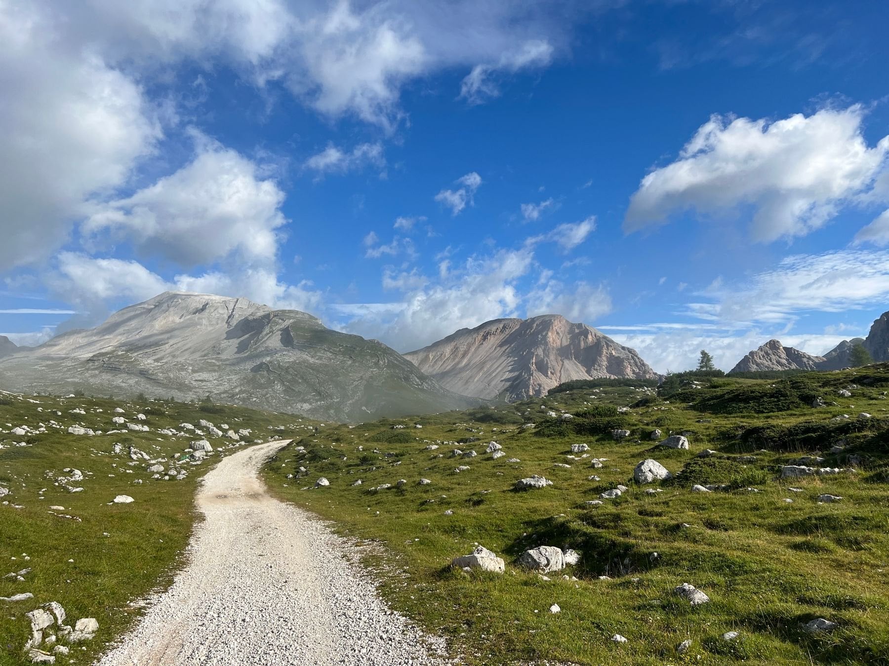 A mountain path winding through a green valley