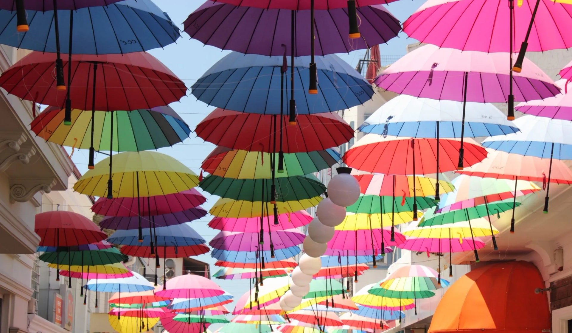 Colorful umbrellas suspended over a street in Fethiye, creating a vibrant canopy.