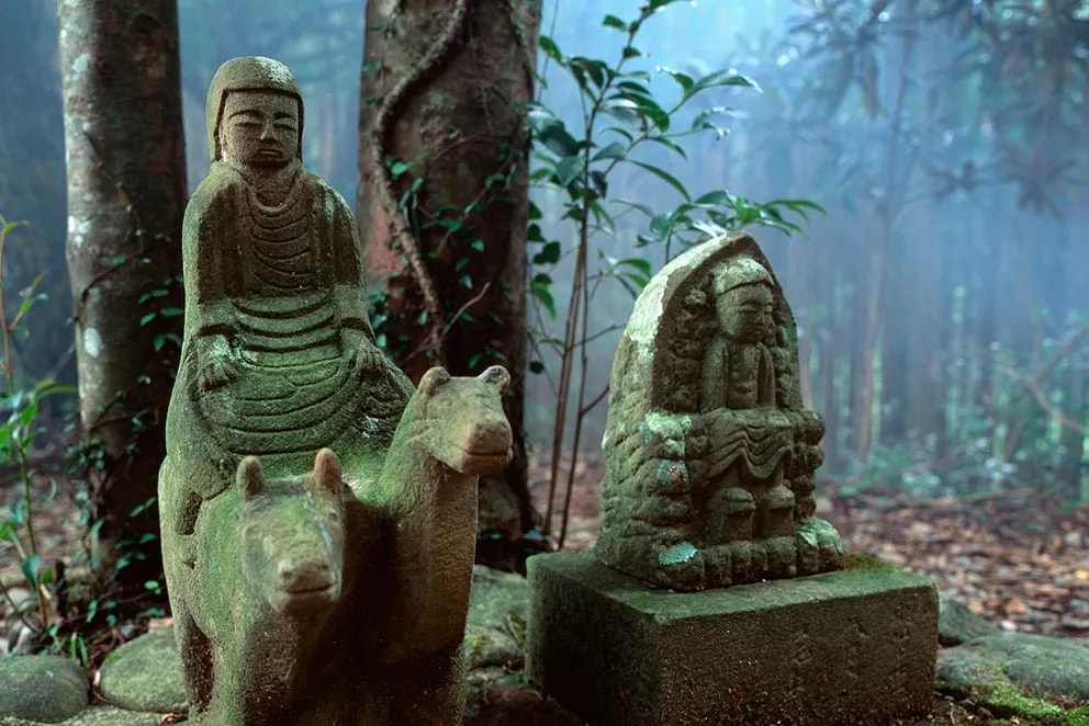 Moss-covered stone statues in a misty forest setting, Gyuba-Doji-Takahara.