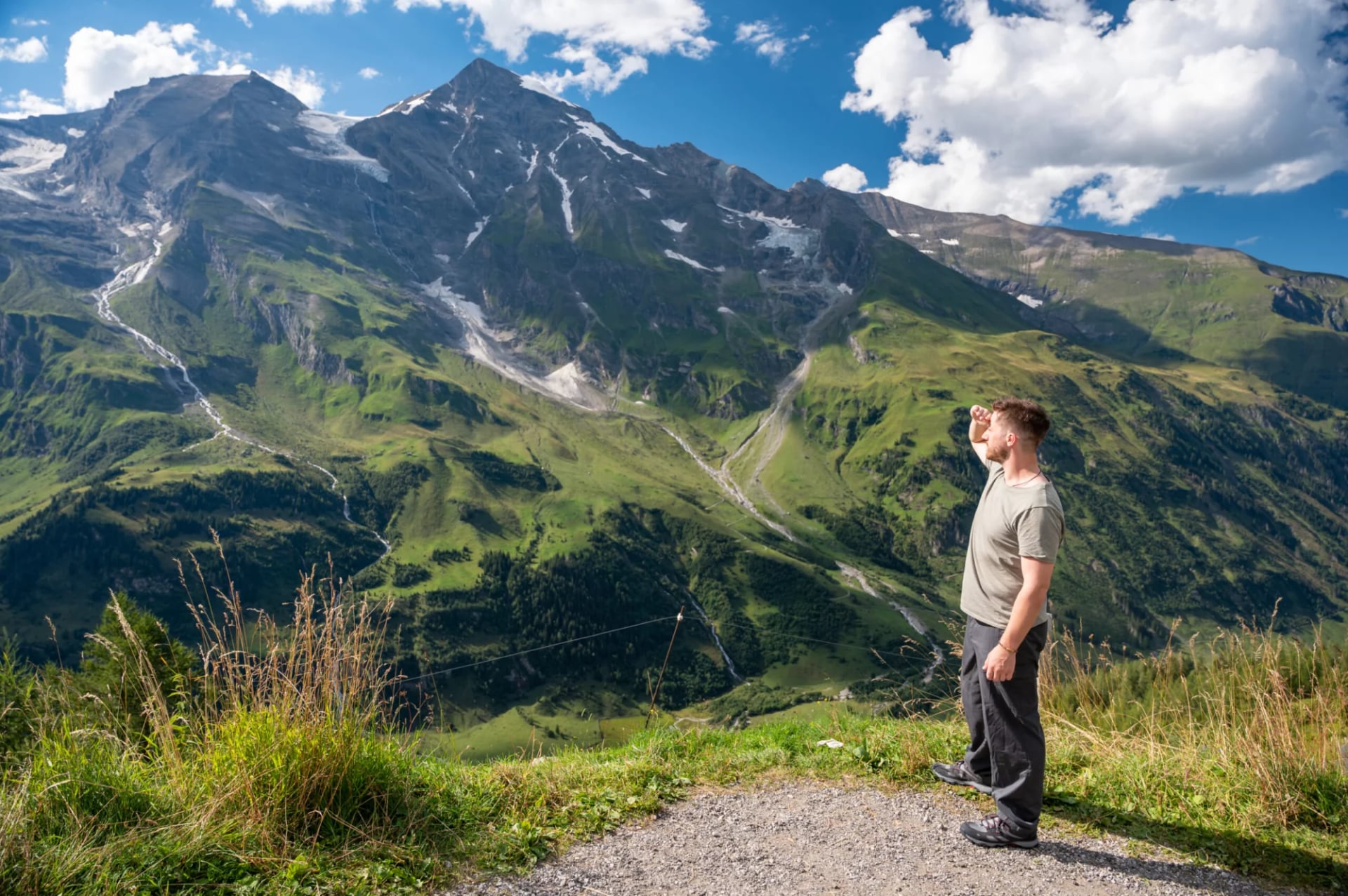 Young man hiking the Grossglockner High Alpine Road, High Tauern National Park, Austria. Austrian Alps, Kitzbühel Alps.