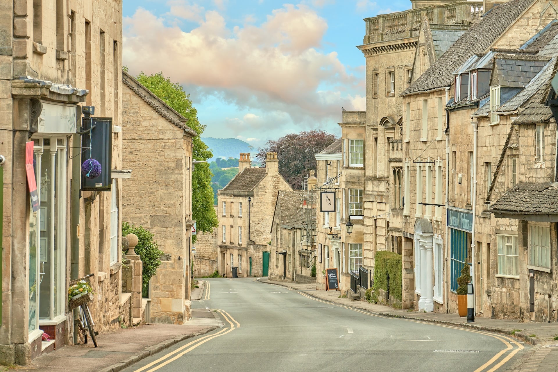 Steep street of pale stone houses in Painswick