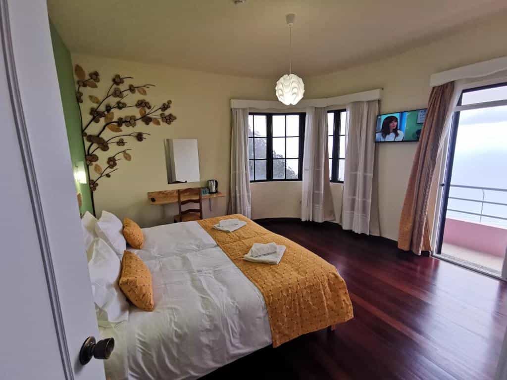 Bedroom in Santana Bed & Breakfast with wood floors and balcony view