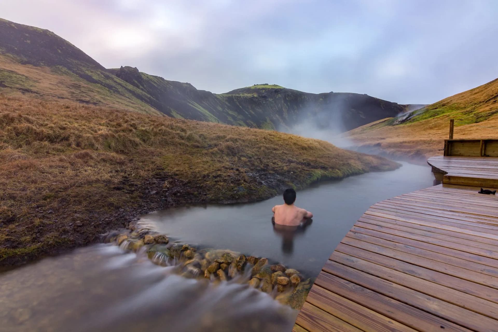 Reykjadalur hot spring thermal river man iceland