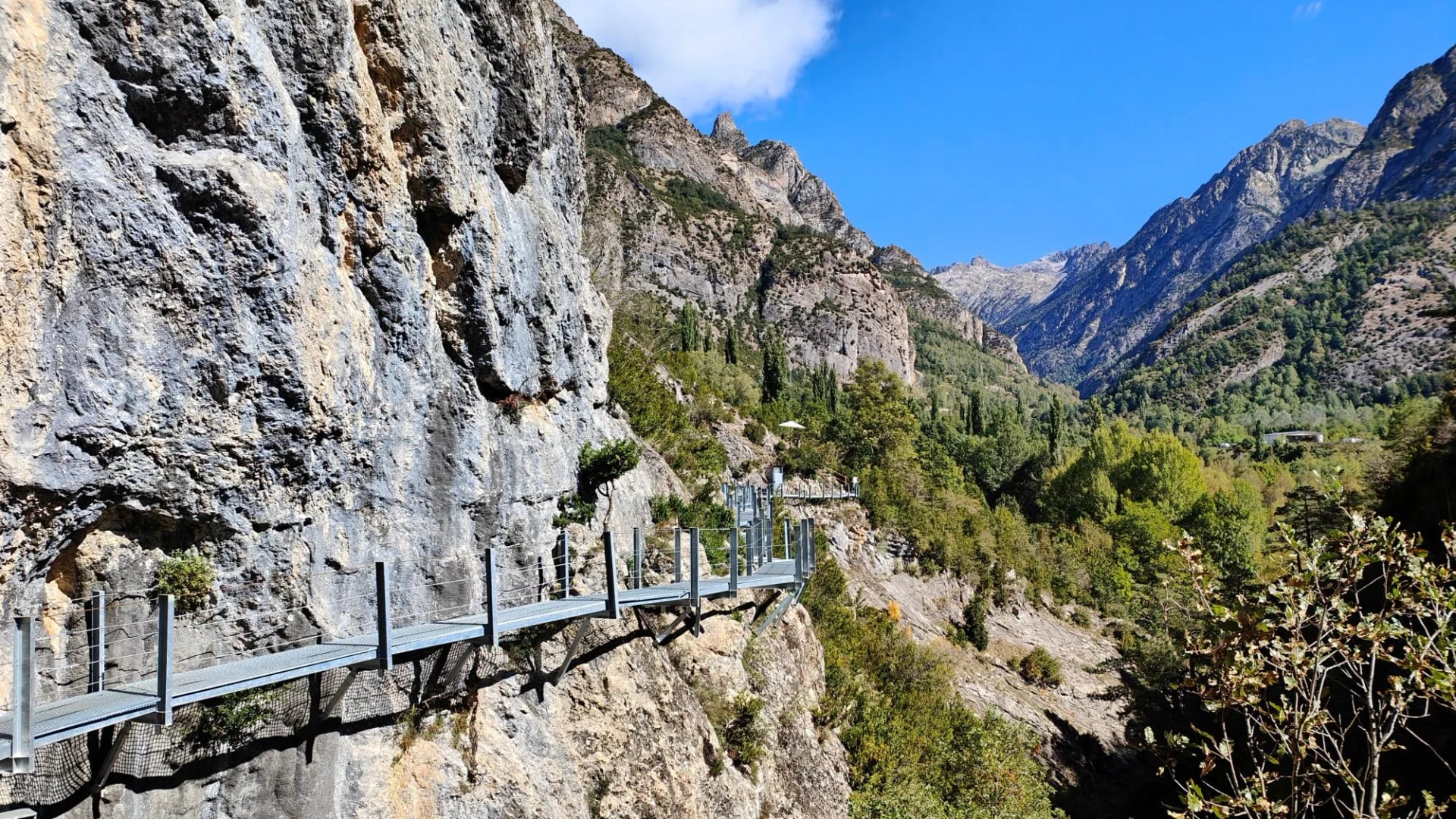Metal walkway bolted to a sheer cliff face above a Pyrenean valley