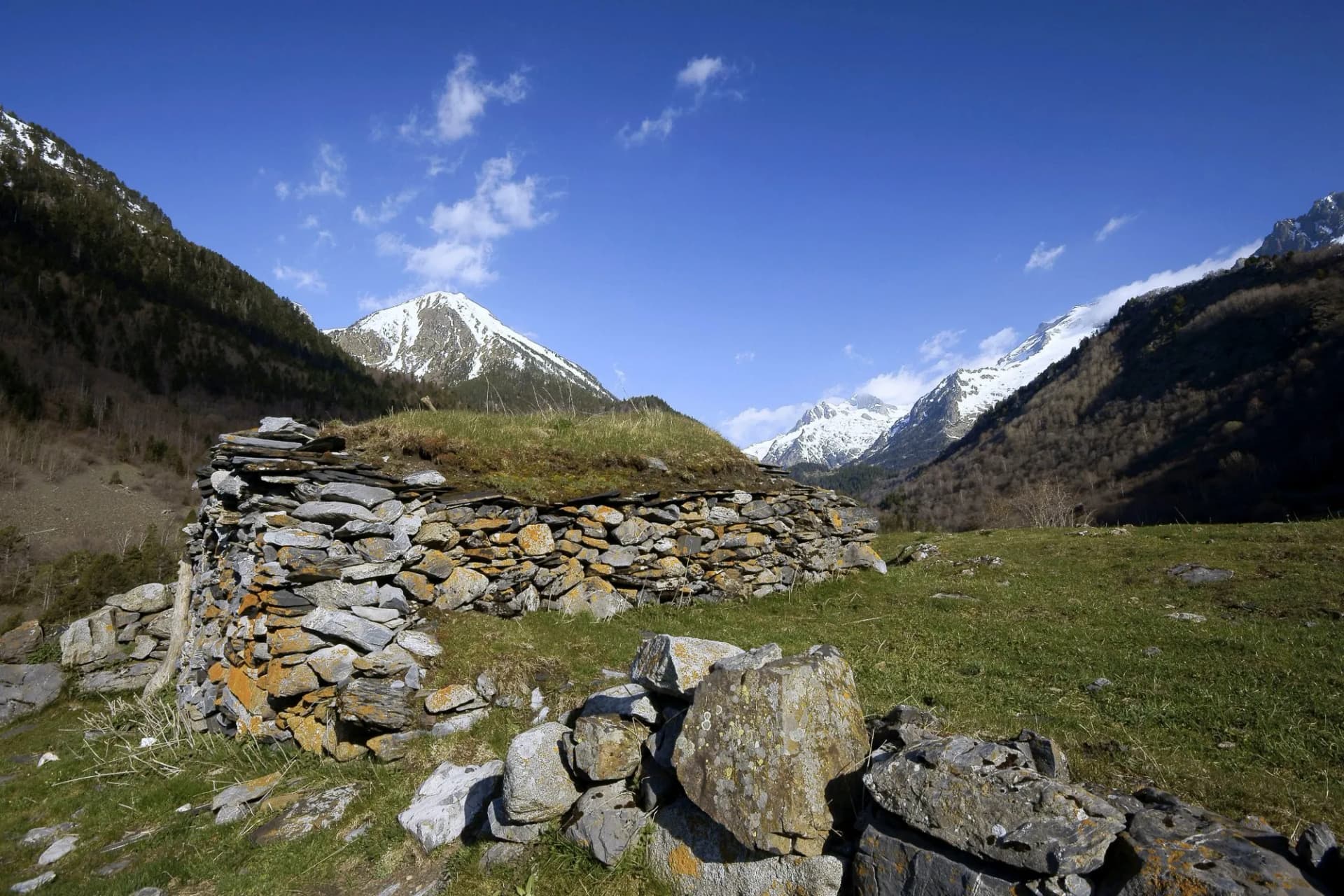 Stone shepherd's hut with grass roof in Valle de Ordesa, Pyrenees, Huesca, Aragon, Spain.