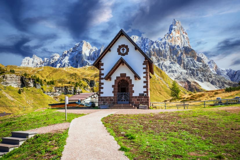 Dolomites, Sudtirol - Italy. Cimon della Pala mountain and the church of Passo Rolle.